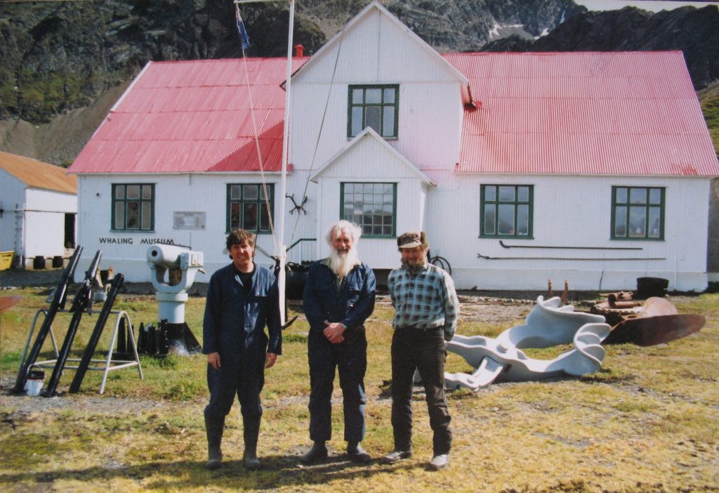Three men in front of teh Grytviken Museum
